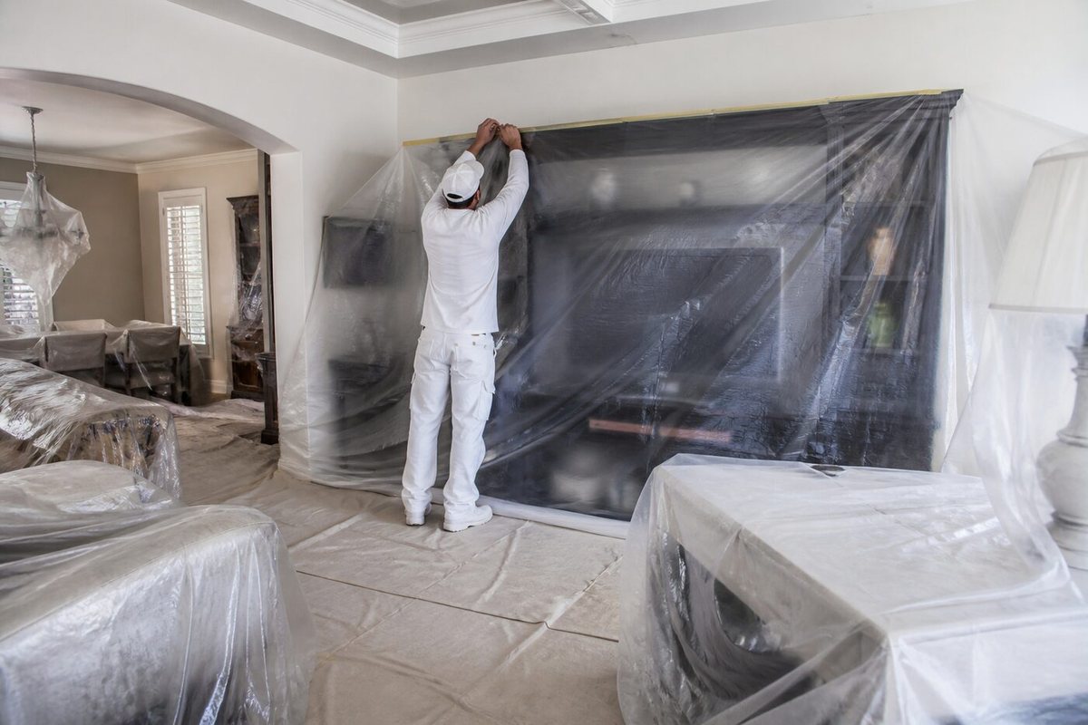 Gold Hands tech protecting furniture before painting a Miami home